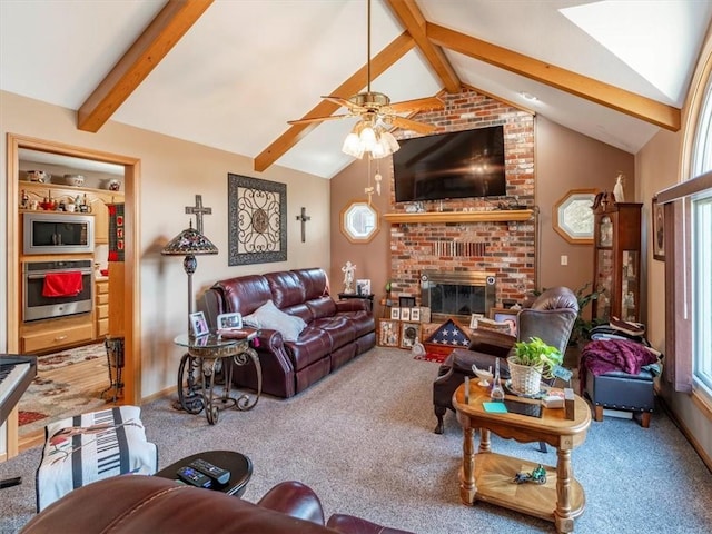 living room featuring baseboards, ceiling fan, lofted ceiling with beams, carpet floors, and a fireplace