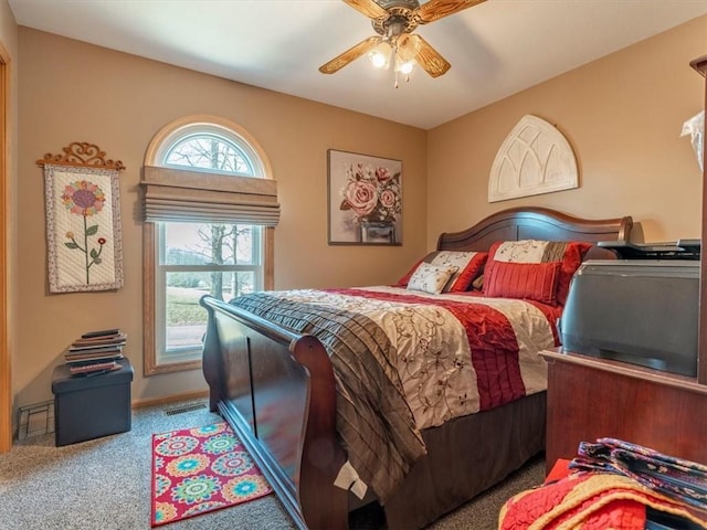 carpeted bedroom with visible vents and ceiling fan