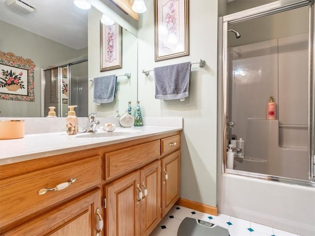 full bathroom with visible vents, vanity, baseboards, and shower / bath combination with glass door