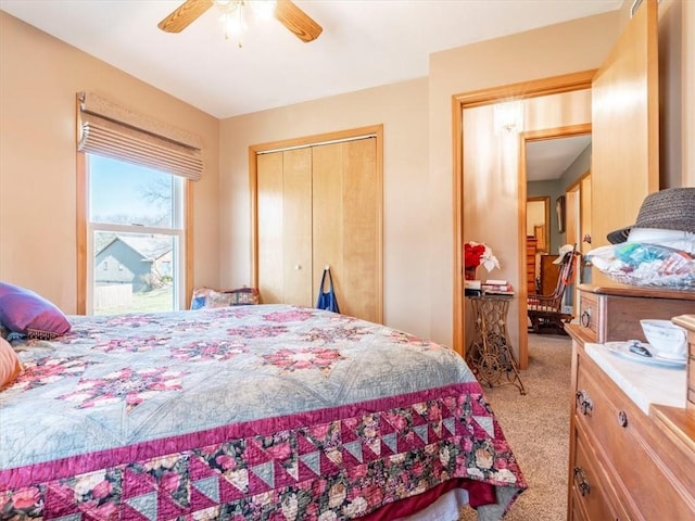 carpeted bedroom featuring a ceiling fan and a closet