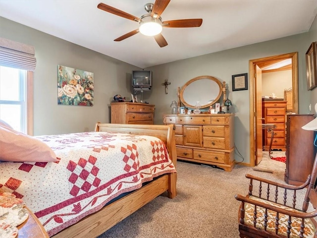 bedroom with light colored carpet and a ceiling fan