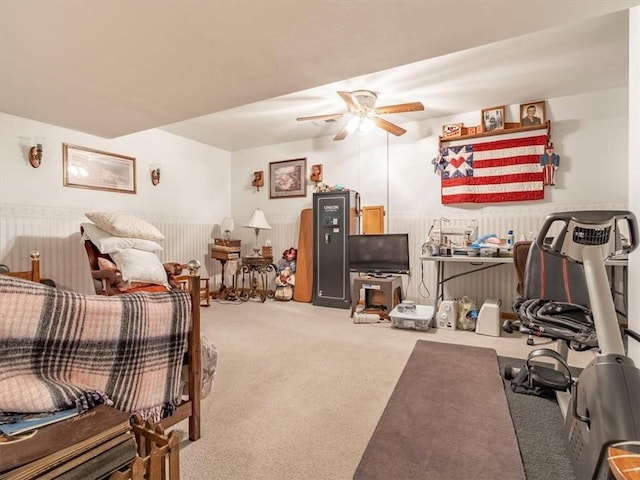 carpeted living area featuring ceiling fan and radiator heating unit