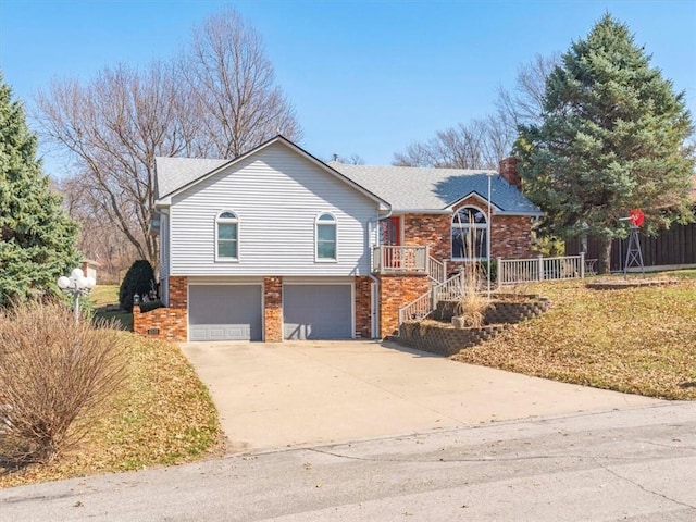 view of front of property featuring brick siding, concrete driveway, roof with shingles, a chimney, and a garage