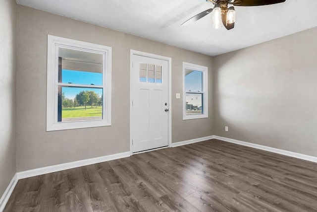 entryway with baseboards, dark wood-style floors, and a ceiling fan