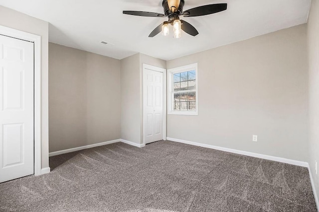 unfurnished bedroom with visible vents, baseboards, carpet, a closet, and a ceiling fan