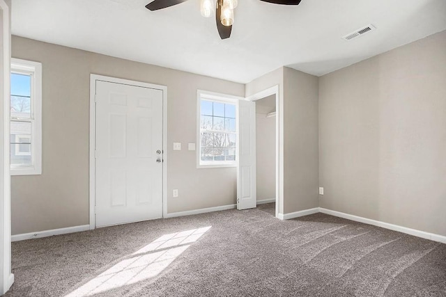 unfurnished bedroom with visible vents, baseboards, and carpet