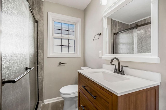 full bathroom featuring toilet, a stall shower, and vanity