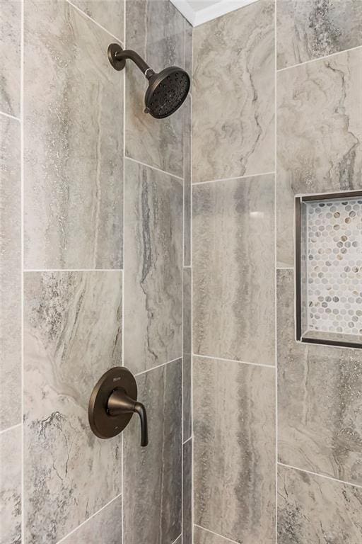 interior details featuring a tile shower