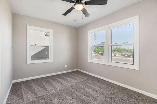 spare room featuring baseboards, carpet, and a ceiling fan