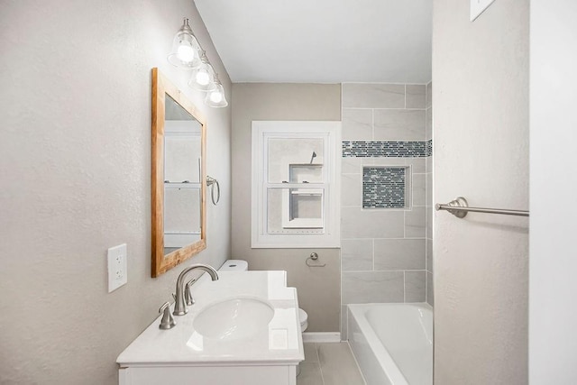 bathroom featuring toilet, vanity, and baseboards