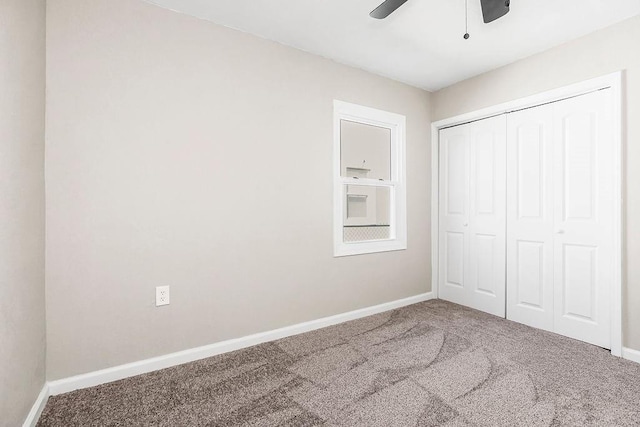 unfurnished bedroom with a closet, a ceiling fan, baseboards, and carpet floors