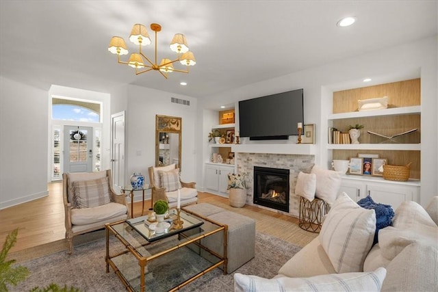 9010 N Denver Ave, Kansas City, MO 64156 - living room featuring a notable chandelier, visible vents, built in features, and wood finished floors