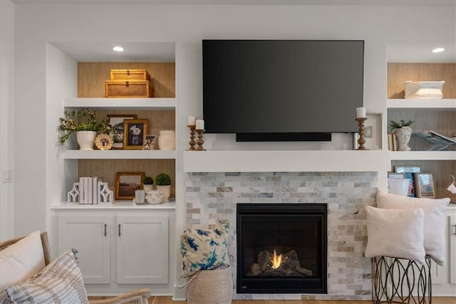 9010 N Denver Ave, Kansas City, MO 64156 - living room featuring built in shelves, recessed lighting, and a brick fireplace
