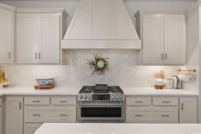 9010 N Denver Ave, Kansas City, MO 64156 - kitchen featuring custom range hood, stainless steel gas range oven, light countertops, and decorative backsplash