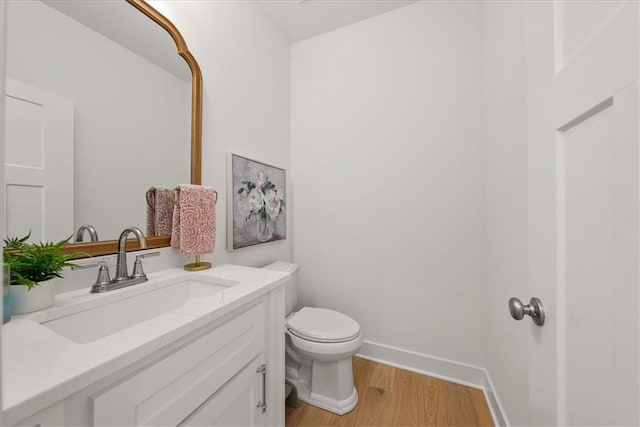 9010 N Denver Ave, Kansas City, MO 64156 - bathroom featuring toilet, wood finished floors, vanity, and baseboards