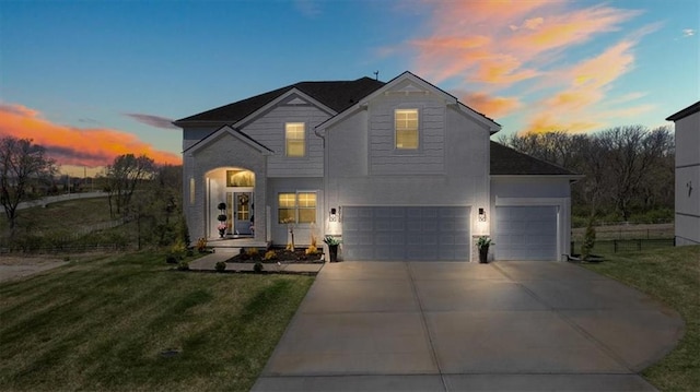9010 N Denver Ave, Kansas City, MO 64156 - french provincial home featuring an attached garage, concrete driveway, and a lawn