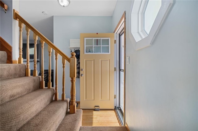 entrance foyer featuring wood finished floors and stairs