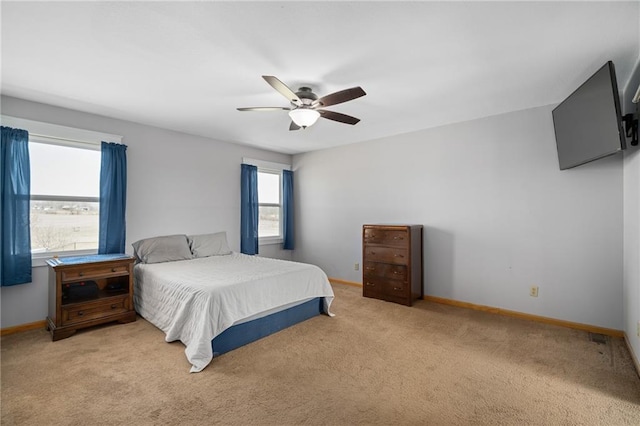 carpeted bedroom featuring baseboards and ceiling fan