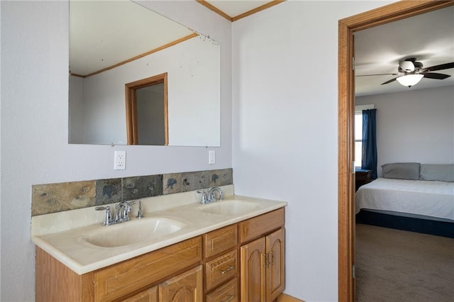 ensuite bathroom featuring double vanity, ensuite bath, crown molding, and a sink