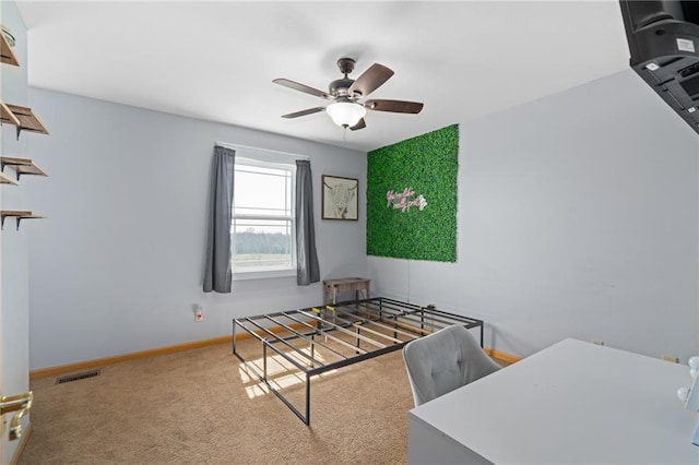 carpeted bedroom with visible vents, ceiling fan, and baseboards