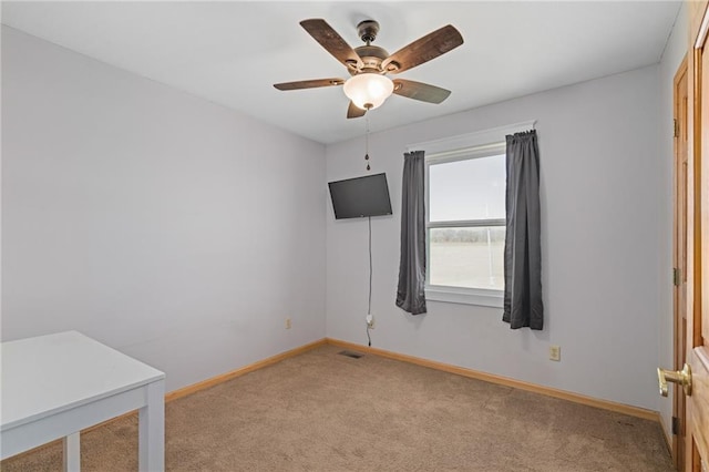 unfurnished room with visible vents, baseboards, and light carpet