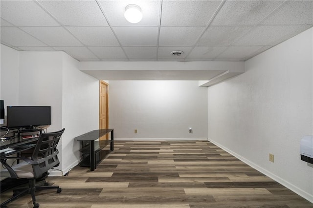 office featuring a drop ceiling, visible vents, baseboards, and wood finished floors