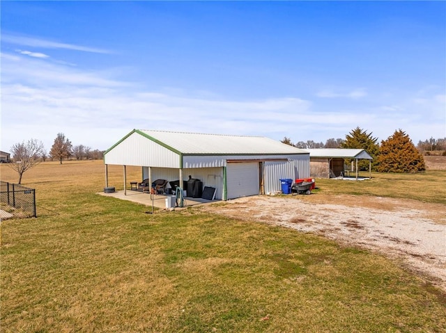 view of pole building with a yard and dirt driveway