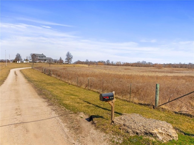 view of road with a rural view and driveway