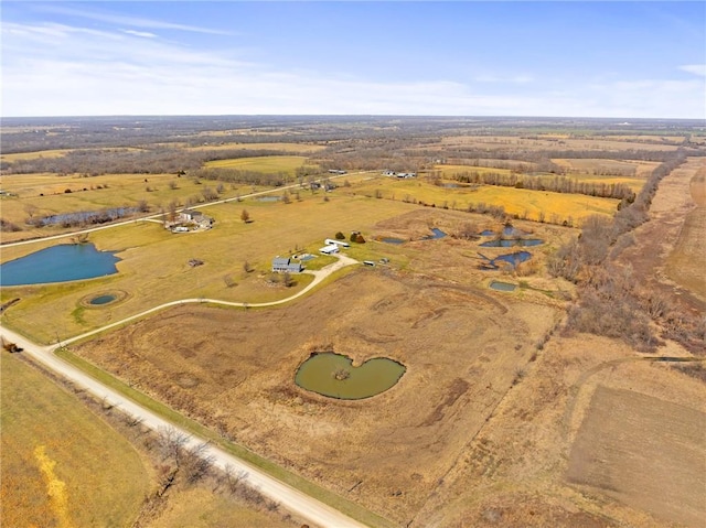 drone / aerial view featuring a water view and a rural view