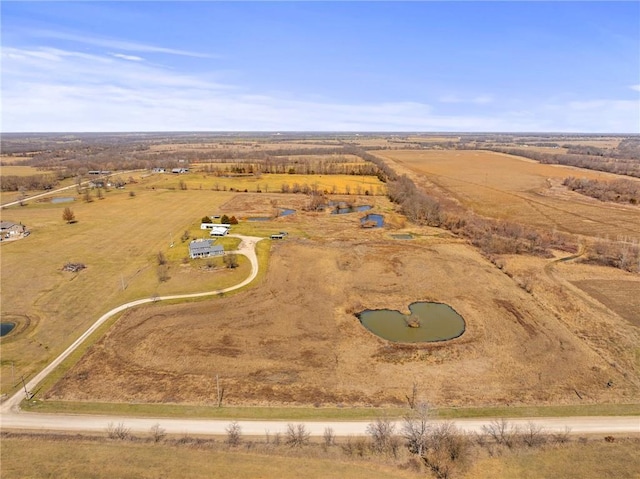 birds eye view of property with a rural view