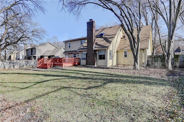 rear view of property with fence, a residential view, a chimney, a yard, and a deck