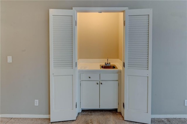 bathroom with baseboards and a sink