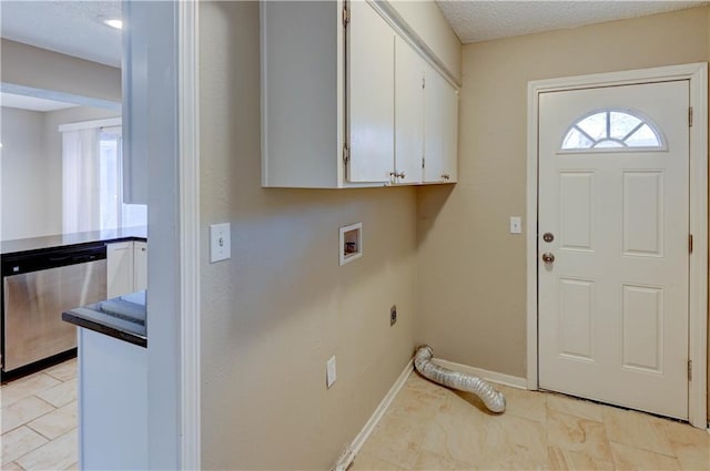 washroom featuring washer hookup, a textured ceiling, cabinet space, baseboards, and hookup for an electric dryer