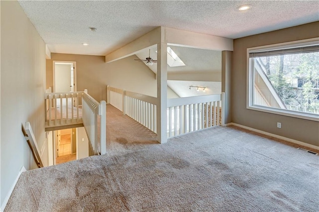 bonus room with a ceiling fan, baseboards, carpet floors, visible vents, and lofted ceiling