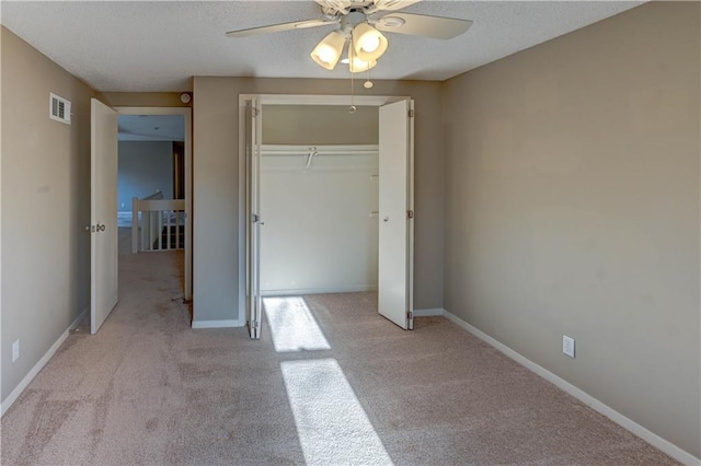 unfurnished bedroom with baseboards, visible vents, a closet, and light carpet