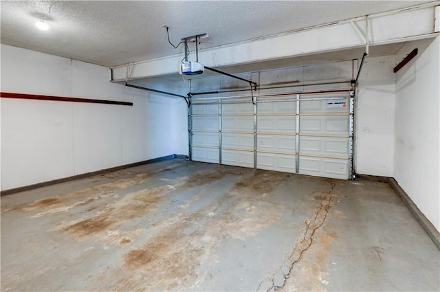 garage with a garage door opener and baseboards