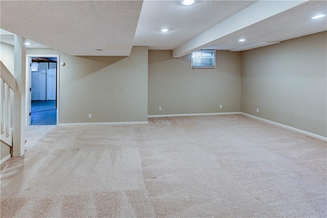 basement featuring recessed lighting, baseboards, a textured ceiling, and carpet flooring