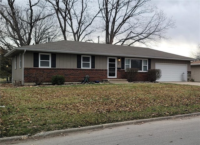 ranch-style house with brick siding, a front lawn, concrete driveway, and a garage