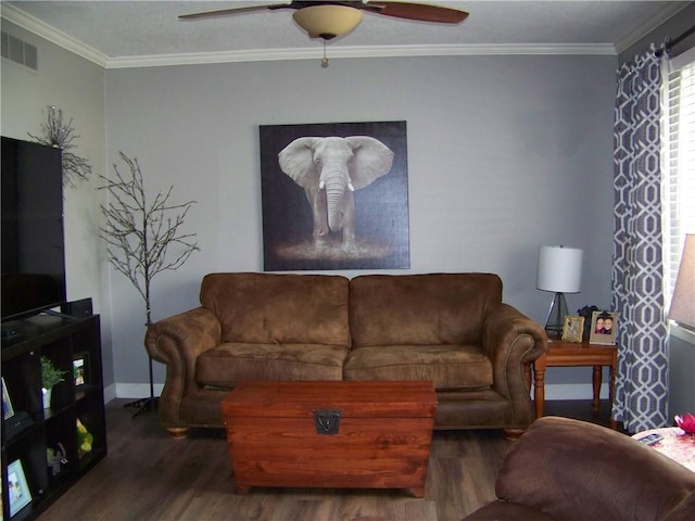 living room with visible vents, crown molding, baseboards, wood finished floors, and a ceiling fan