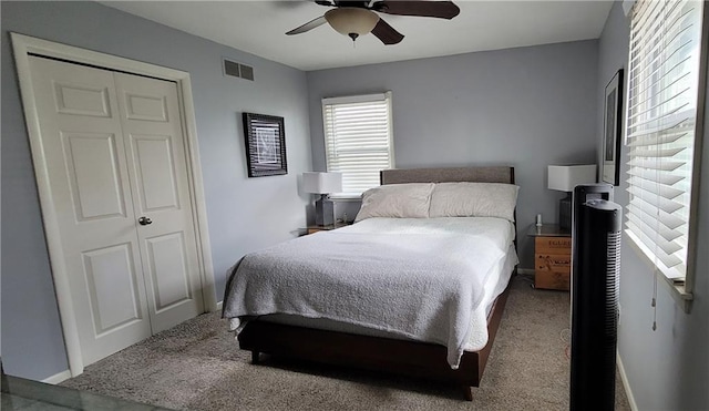 carpeted bedroom with visible vents and ceiling fan