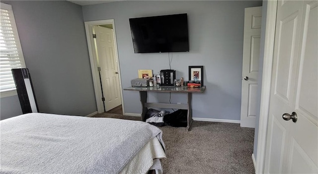 bedroom with baseboards and carpet