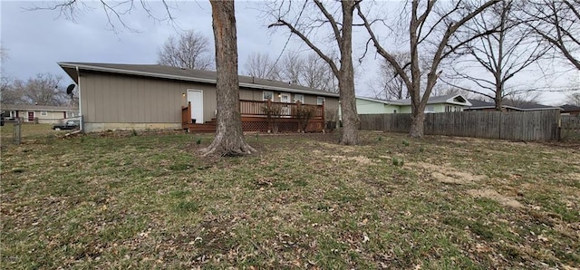 view of yard with fence and a wooden deck