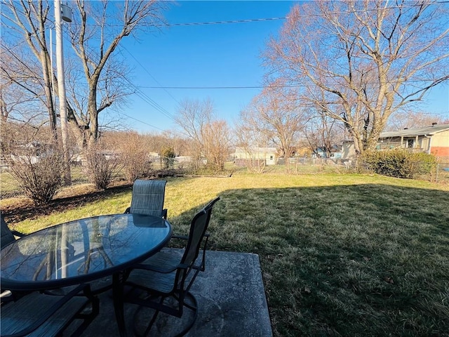 view of yard featuring outdoor dining area and fence