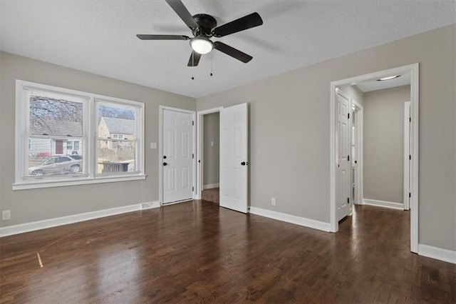 3403 Norton Ave, Kansas City, MO 64128 - unfurnished bedroom featuring wood finished floors, baseboards, and a textured ceiling