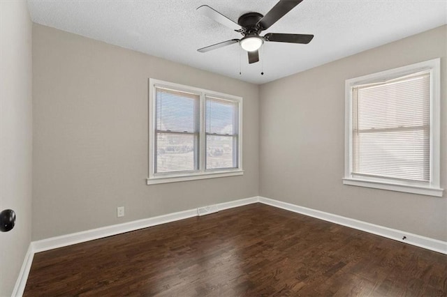 3403 Norton Ave, Kansas City, MO 64128 - unfurnished room featuring a ceiling fan, dark wood-style floors, baseboards, and a textured ceiling