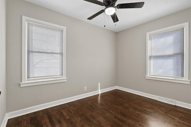 3403 Norton Ave, Kansas City, MO 64128 - empty room with visible vents, ceiling fan, baseboards, and dark wood-style flooring