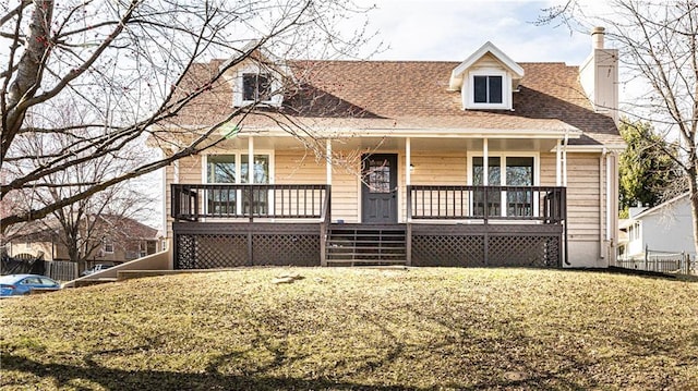 cape cod-style house with central air condition unit, a front lawn, covered porch, a shingled roof, and a chimney