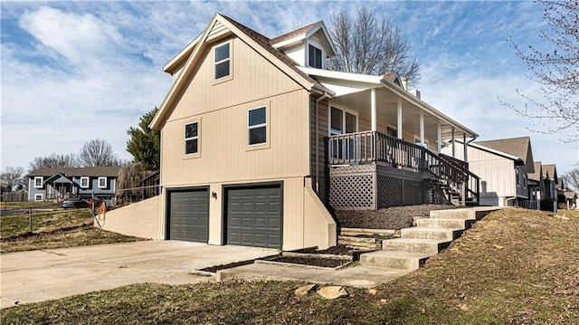 view of home's exterior featuring a garage, driveway, covered porch, and stairs