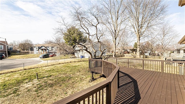 wooden terrace featuring a yard and a residential view