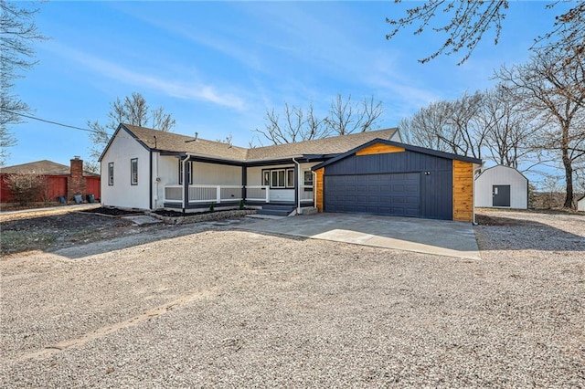 view of front of home featuring a porch, an attached garage, and driveway